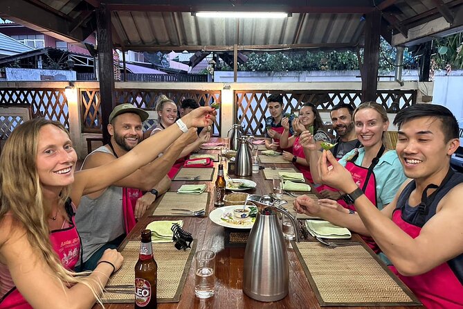 Authentic Thai Cooking Class and Farm Visit in Chiang Mai - Learning in an open-air kitchen