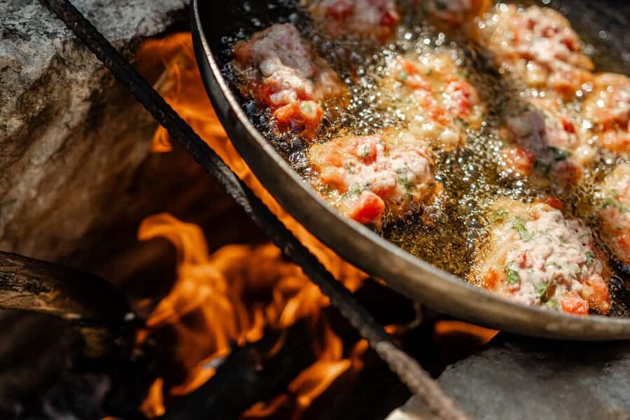 Naxos: Family Farm-table Cooking, Kouros Tour & Live Music - Cooking over an open fire and wood stove